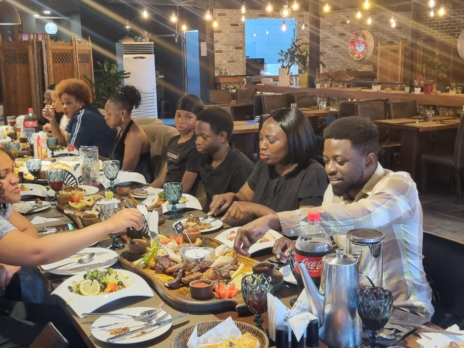 Families sharing a platter at the USKA community dinner, 16 August 2026