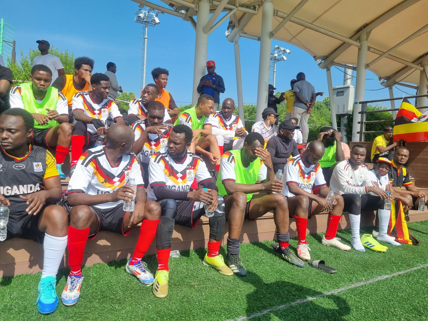 Team Uganda players resting on the bench during KAFCON 2026