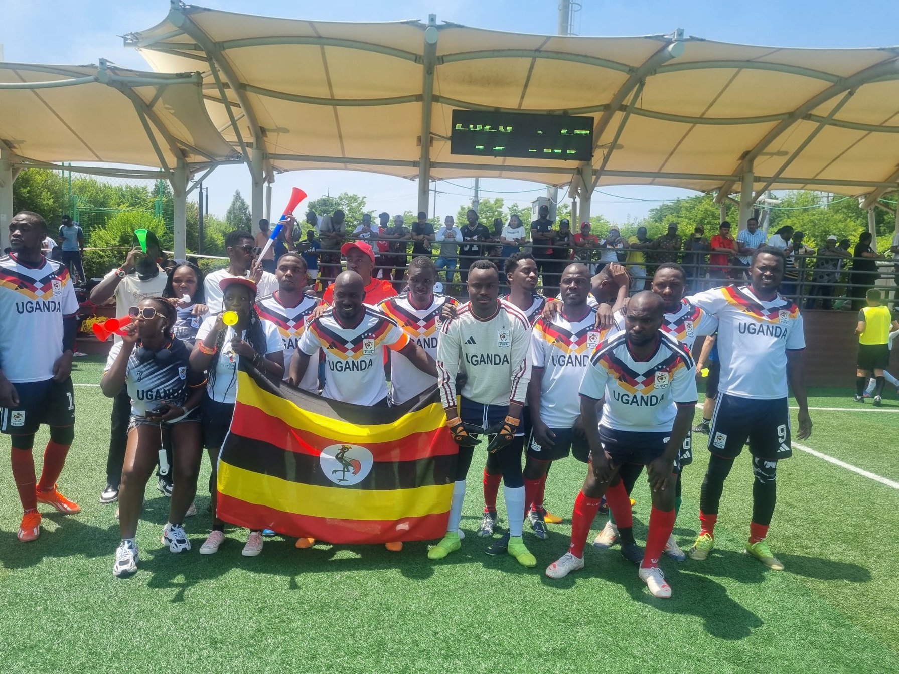 Team Uganda squad and supporters with the national flag at KAFCON 2026