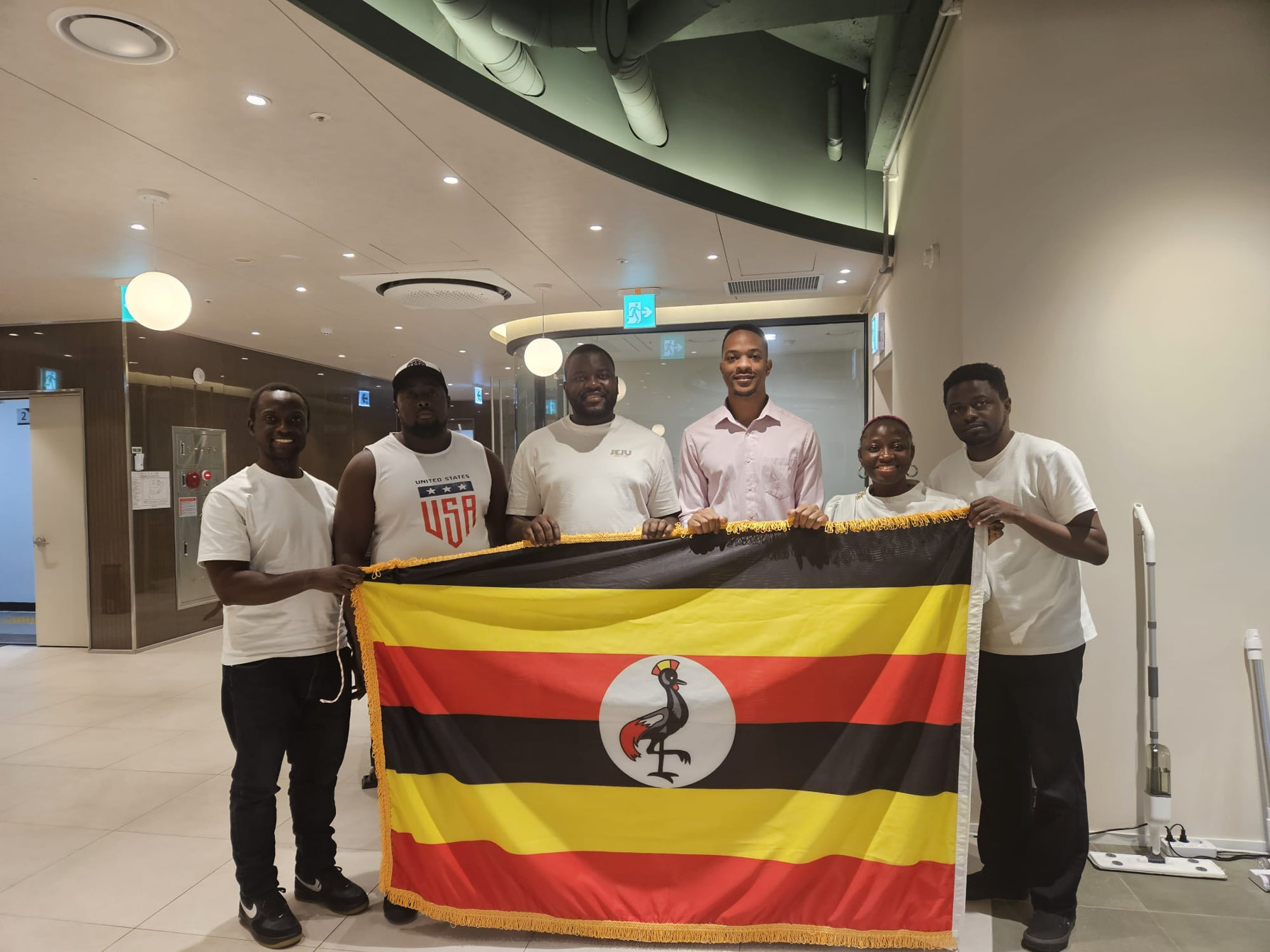 USKA members holding the Uganda flag — leadership transition announcement, July 2026