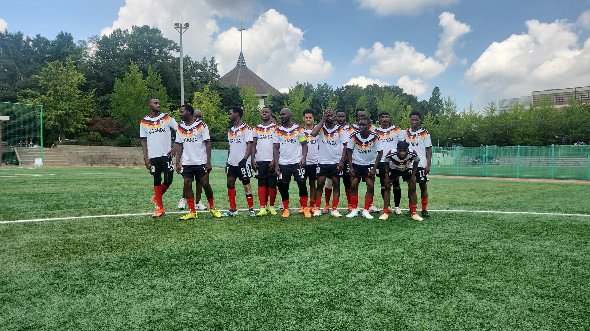 Team Uganda standing for the team photograph at Ajou University, 26 July 2026