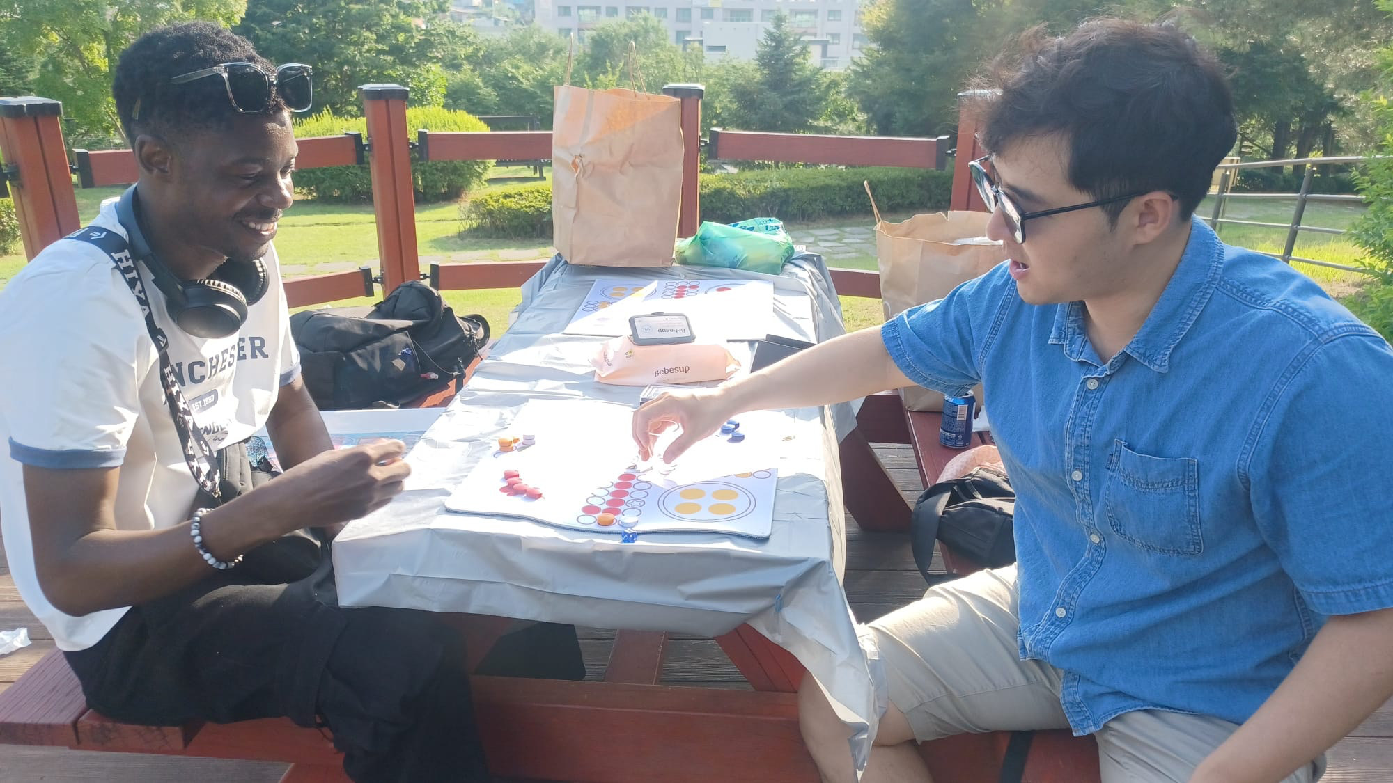 Friends playing board games at the Songtan park get-together