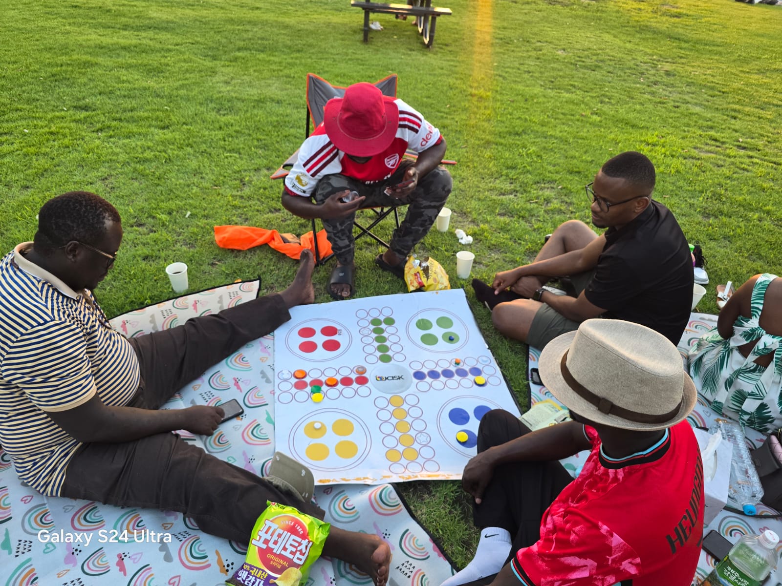 Members playing Ludo on a picnic mat at the USKA Banpo gathering, 1 August 2026