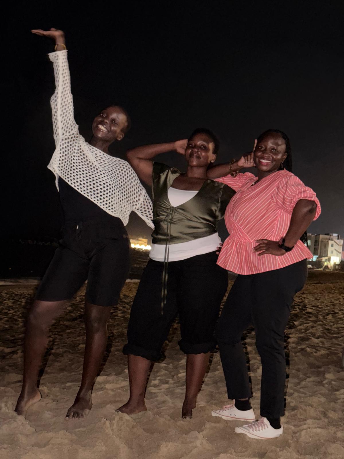Three USKA members posing on the sand at Bongpo Beach at night, 15 August 2026